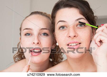 Teenage girls applying makeup View Large Photo Image Stock Photo - Teenage girls applying makeup. Fotosearch