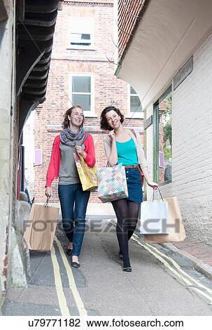 Teenage girls carrying shopping bags View Large Photo Image Stock Image - Teenage girls carrying shopping bags. Fotosearch