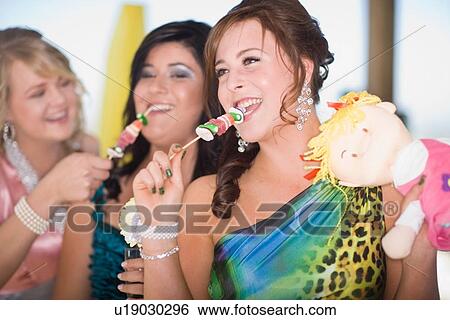 Teenage girls in gowns eating kebabs View Large Photo Image Stock Photograph - Teenage girls in gowns eating kebabs. Fotosearch