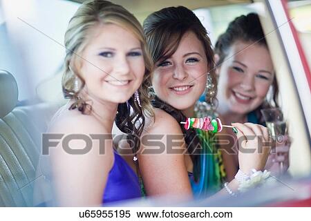 Stock Photography - Teenage girls in gowns eating kebabs. Fotosearch