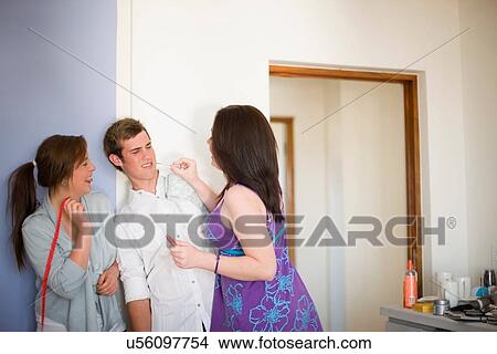 Teenage girls putting makeup on boy View Large Photo Image Picture - Teenage girls putting makeup on boy. Fotosearch