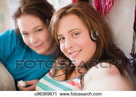Stock Image - Teenage girls smiling together. Fotosearch
