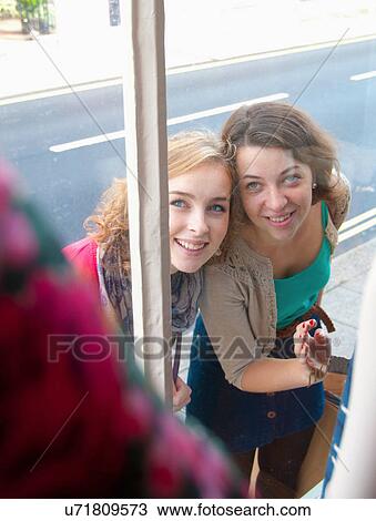 Teenage girls window shopping together View Large Photo Image Stock Image - Teenage girls window shopping together. Fotosearch