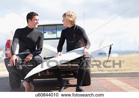 Teenage surfers with board in truck bed View Large Photo Image Stock Image - Teenage surfers with board in truck bed. Fotosearch