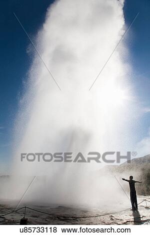Teenager looking at steaming geyser View Large Photo Image Stock Photo - Teenager looking at steaming geyser. Fotosearch