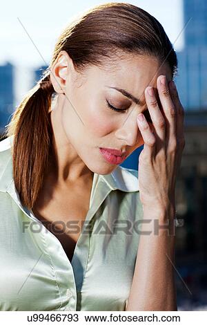 Tired businesswoman holding her head View Large Photo Image Stock Image - Tired businesswoman holding her head. Fotosearch