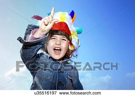 Toddler girl wearing Indian headdress View Large Photo Image Stock Photo - Toddler girl wearing Indian headdress. Fotosearch