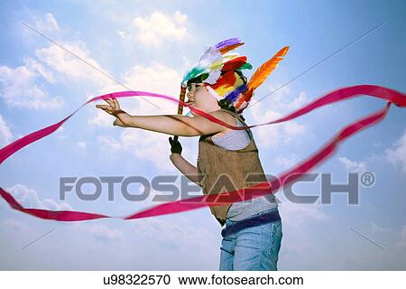 Stock Image - Toddler in Indian headdress with ribbon. Fotosearch