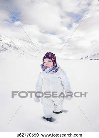 Toddler walking in snowy landscape View Large Photo Image Stock Image - Toddler walking in snowy landscape. Fotosearch