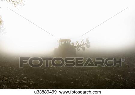 Tractor driving through fog View Large Photo Image Stock Photo - Tractor driving through fog. Fotosearch