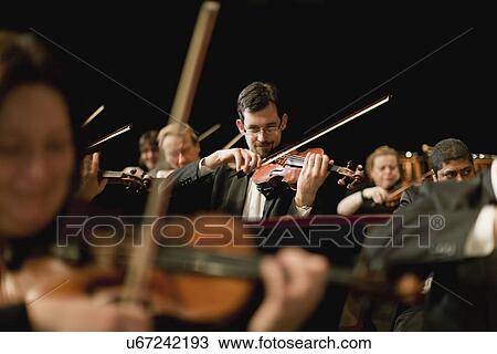 Violin players in orchestra View Large Photo Image Stock Image - Violin players in orchestra. Fotosearch