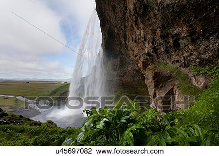 Waterfall over sheer rock cliff View Large Photo Image Stock Image - Waterfall over sheer rock cliff. Fotosearch