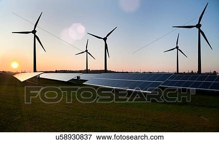 Wind turbines and solar panels in field View Large Photo Image Stock Photo - Wind turbines and solar panels in field. Fotosearch