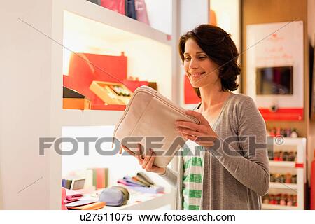 Woman admiring laptop case in store View Large Photo Image Stock Photography - Woman admiring laptop case in store. Fotosearch
