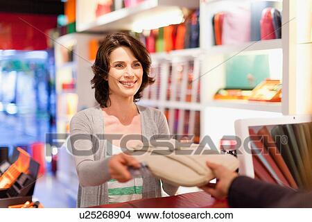 Woman buying purse in store View Large Photo Image Picture - Woman buying purse in store. Fotosearch
