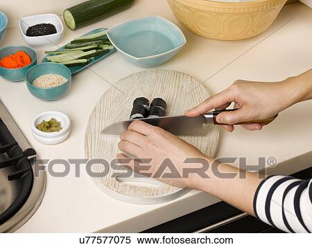 Woman chopping sushi at table View Large Photo Image Stock Photography - Woman chopping sushi at table. Fotosearch