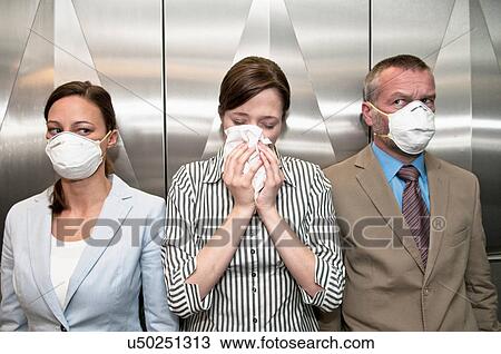 Woman coughing around others in elevator View Large Photo Image Stock Image - Woman coughing around others in elevator. Fotosearch
