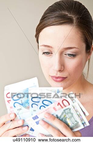 Stock Image - Woman counting Euro bills. Fotosearch