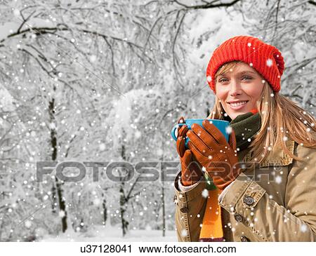 Woman drinking coffee in snow View Large Photo Image Stock Image - Woman drinking coffee in snow. Fotosearch