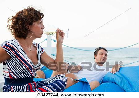 Woman drinking wine outdoors View Large Photo Image Picture - Woman drinking wine outdoors. Fotosearch