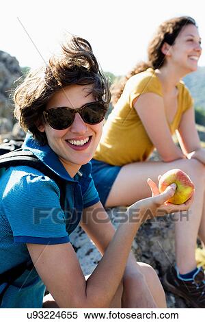Woman eating apple outdoors View Large Photo Image Stock Photography - Woman eating apple outdoors. Fotosearch
