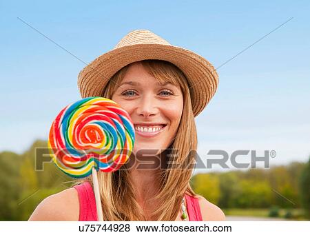 Woman eating lollipop outdoors View Large Photo Image Stock Photo - Woman eating lollipop outdoors. Fotosearch