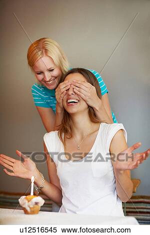 Woman giving friend birthday cupcake View Large Photo Image Stock Photography - Woman giving friend birthday cupcake. Fotosearch