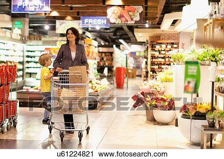 Woman grocery shopping with son View Large Photo Image Stock Image - Woman grocery shopping with son. Fotosearch