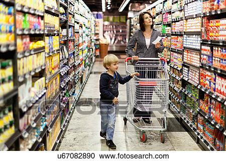 Woman grocery shopping with son View Large Photo Image Stock Image - Woman grocery shopping with son. Fotosearch