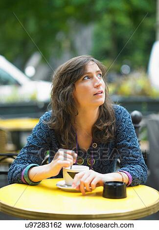 Woman having coffee at sidewalk cafe View Large Photo Image Stock Image - Woman having coffee at sidewalk cafe. Fotosearch