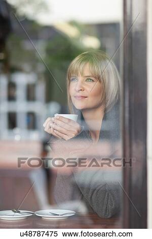 Woman having cup of coffee in cafe View Large Photo Image Stock Photography - Woman having cup of coffee in cafe. Fotosearch