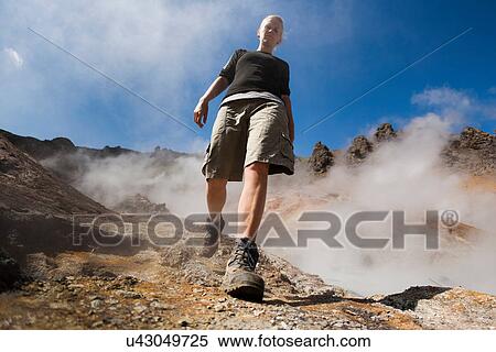 Woman hiking near geyser View Large Photo Image Stock Photography - Woman hiking near geyser. Fotosearch