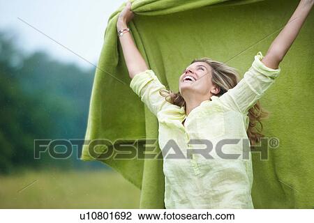 Woman holding blanket outdoors View Large Photo Image Stock Image - Woman holding blanket outdoors. Fotosearch