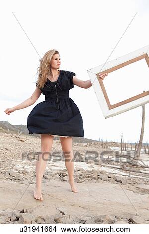 Woman holding empty picture frame View Large Photo Image Picture - Woman holding empty picture frame. Fotosearch