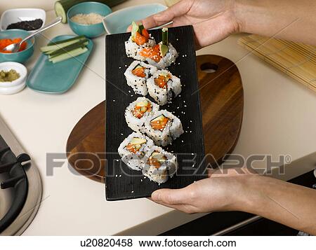 Woman holding tray of sushi View Large Photo Image Stock Photo - Woman holding tray of sushi. Fotosearch