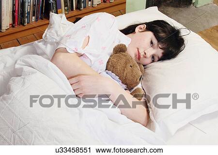 Woman hugging teddy bear in bed View Large Photo Image Stock Image - Woman hugging teddy bear in bed. Fotosearch