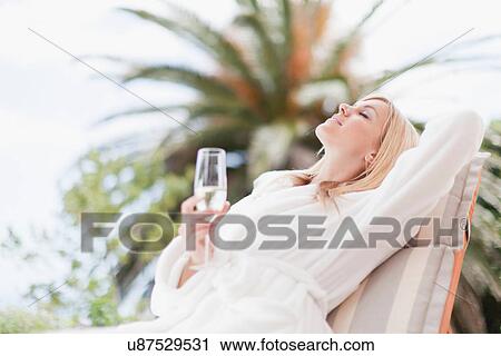 Woman in bathrobe relaxing in lawn chair View Large Photo Image Stock Image - Woman in bathrobe relaxing in lawn chair. Fotosearch