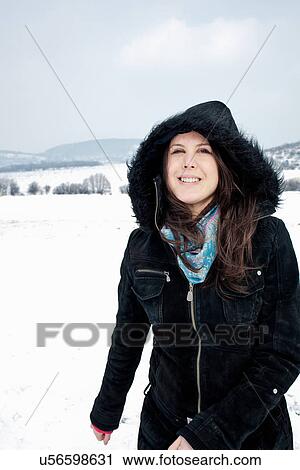 Woman in parka walking in snow View Large Photo Image Stock Image - Woman in parka walking in snow. Fotosearch