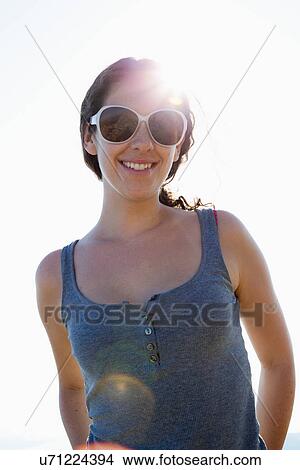 Picture - Woman in sunglasses smiling. Fotosearch