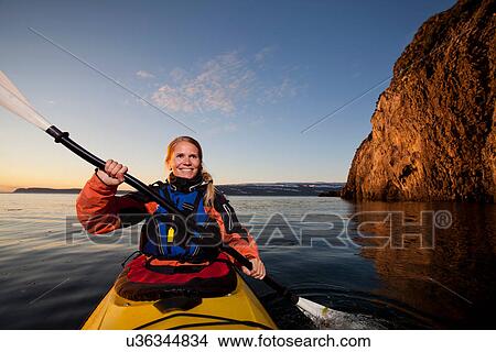 Woman kayaking in still lake View Large Photo Image Picture - Woman kayaking in still lake. Fotosearch