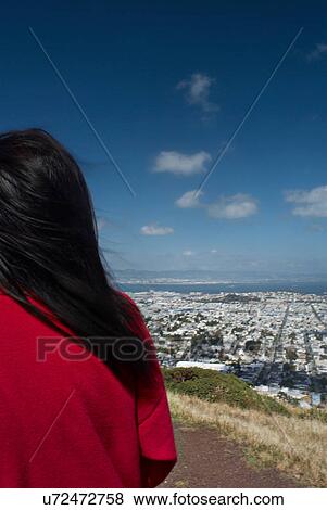 Woman on hill overlooking cityscape View Large Photo Image Stock Photo - Woman on hill overlooking cityscape. Fotosearch