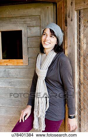 Picture - Woman peering around doorway. Fotosearch