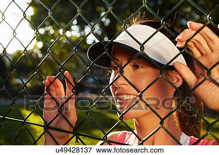 Woman peering through chain link fence View Large Photo Image Stock Photo - Woman peering through chain link fence. Fotosearch
