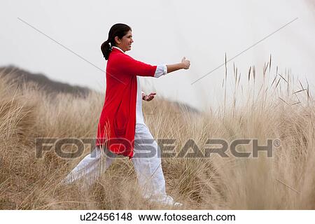 Woman practicing yoga on beach View Large Photo Image Stock Photo - Woman practicing yoga on beach. Fotosearch