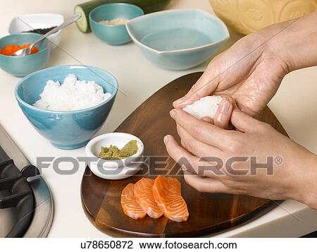Woman preparing sushi at table View Large Photo Image Stock Image - Woman preparing sushi at table. Fotosearch
