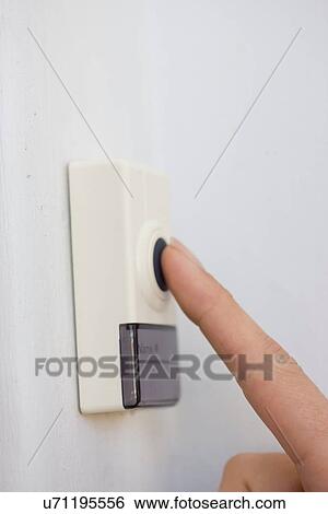 Stock Photograph - Woman pressing button. Fotosearch