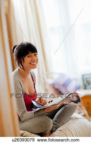 Woman reading magazine in bed View Large Photo Image Stock Photo - Woman reading magazine in bed. Fotosearch