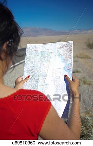 Woman reading map on rural road View Large Photo Image Stock Image - Woman reading map on rural road. Fotosearch
