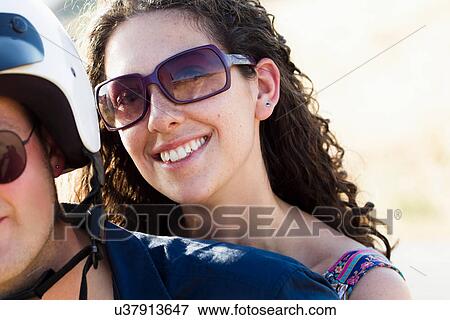 Woman riding scooter with friend View Large Photo Image Stock Photo - Woman riding scooter with friend. Fotosearch