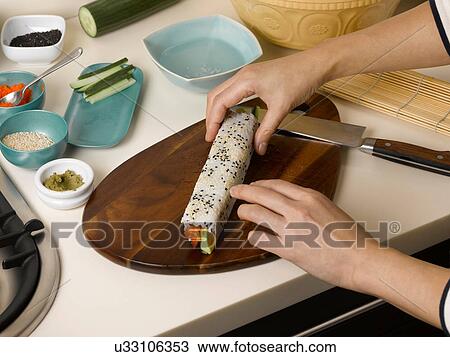 Woman rolling sushi at table View Large Photo Image Stock Image - Woman rolling sushi at table. Fotosearch